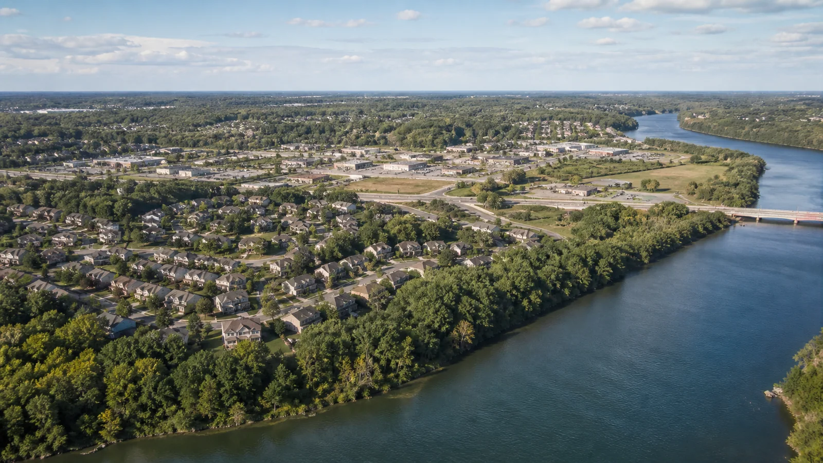 Editorial wide view of Mississippi River, Elm Creek natural areas, established neighborhoods, commercial districts, and redevelopment sites in Champlin